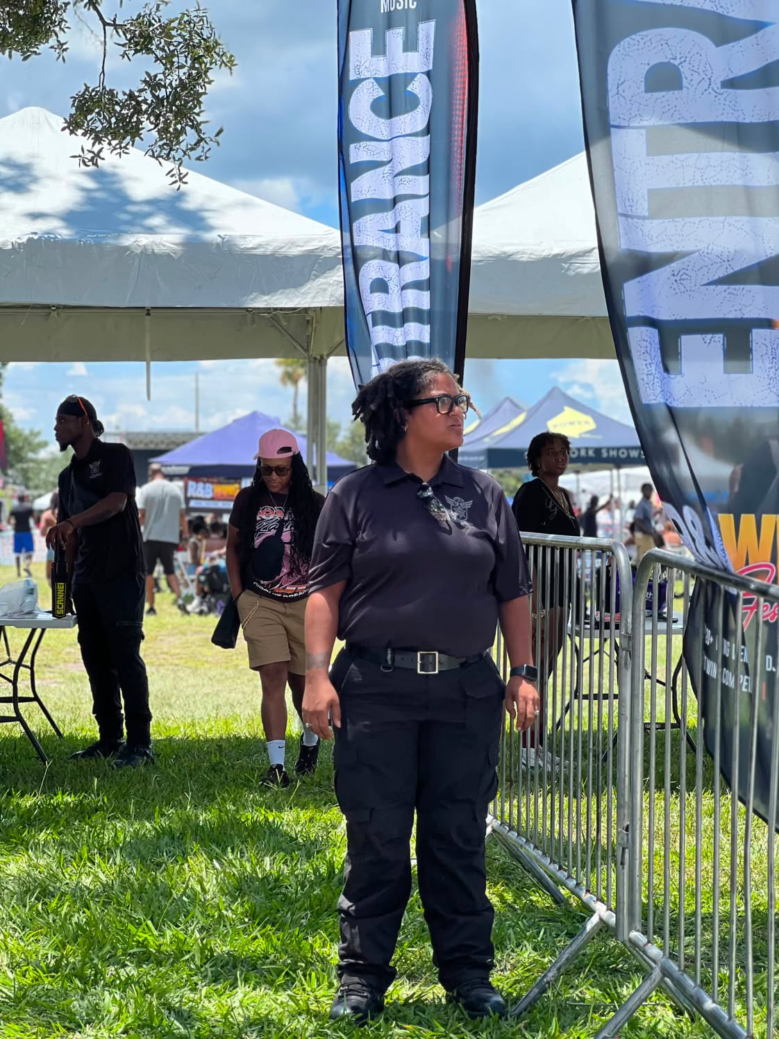 Trust Point Security officer posted at the festival entrance with metal detection screening behind
