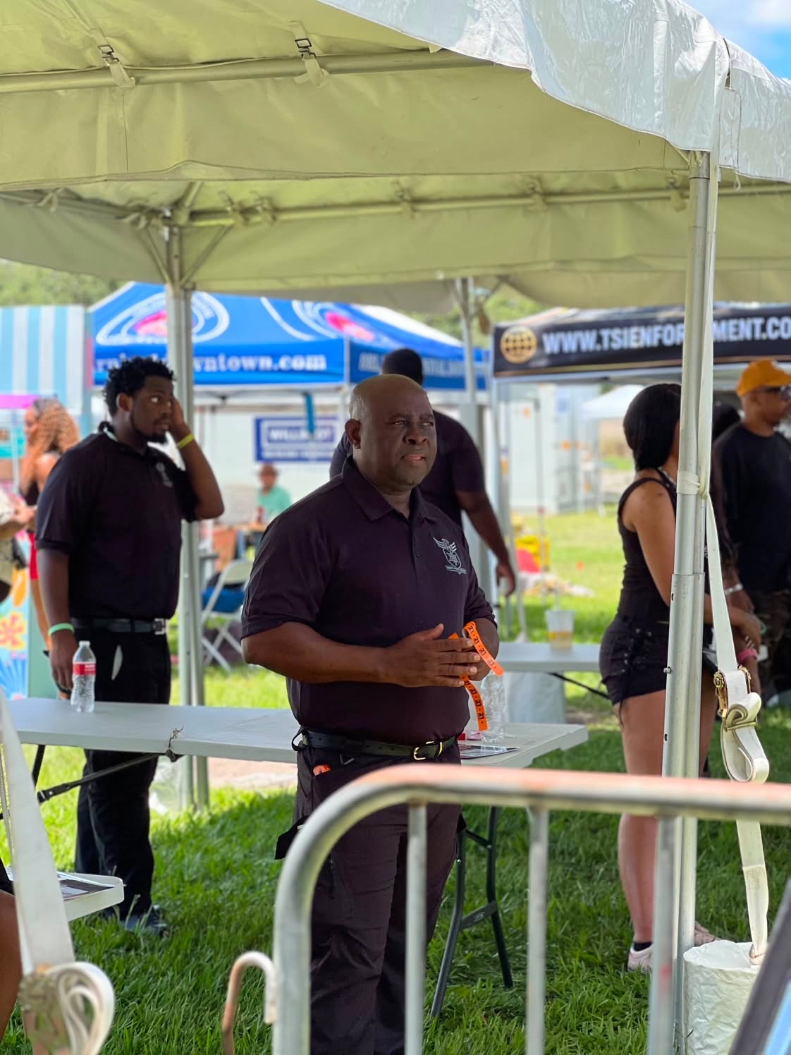 Trust Point Security supervisor managing wristband distribution at a festival entrance
