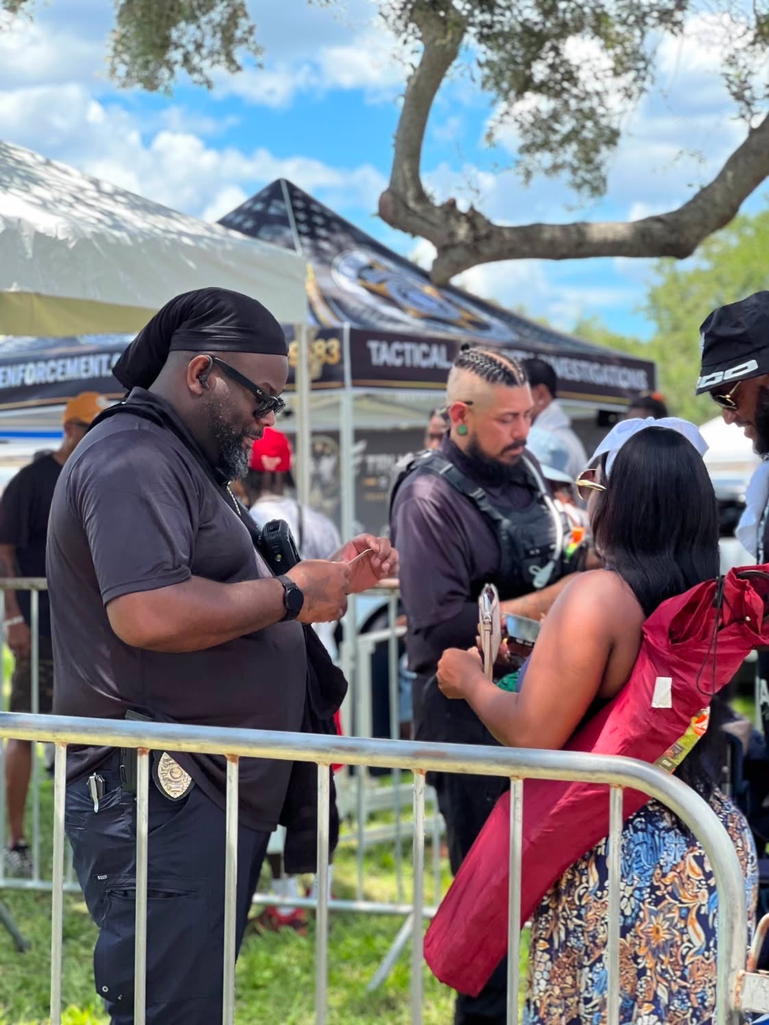 Trust Point Security officer verifying credentials at the barricade line
